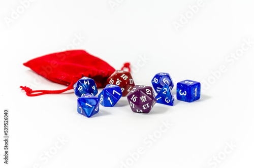 Dice for playing dnd and rpg. dice set of dice for fantasy tabletop games. Twenty-Sided die in front of other polyhedral dice used for games. Isolated on white. selective focus  Shallow depth of field