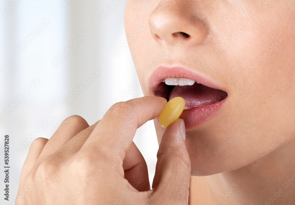 Supplement concept with woman take pill