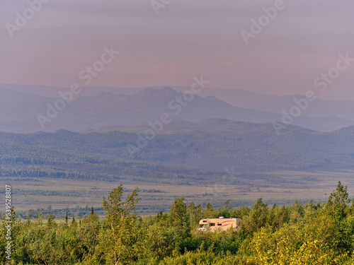 A lone motor home camping at sunset just off the Dalton Highway in Alaska north of Coldfoot with the majestic mountains in the background photo