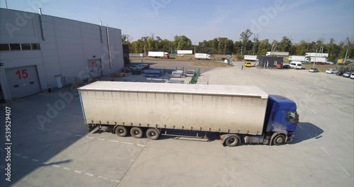 White truck leaves the warehouse after being loaded with goods. Logistics warehouse truck goes to customers with goods