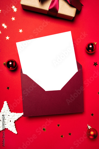 Envelope with letter and gift on a red background