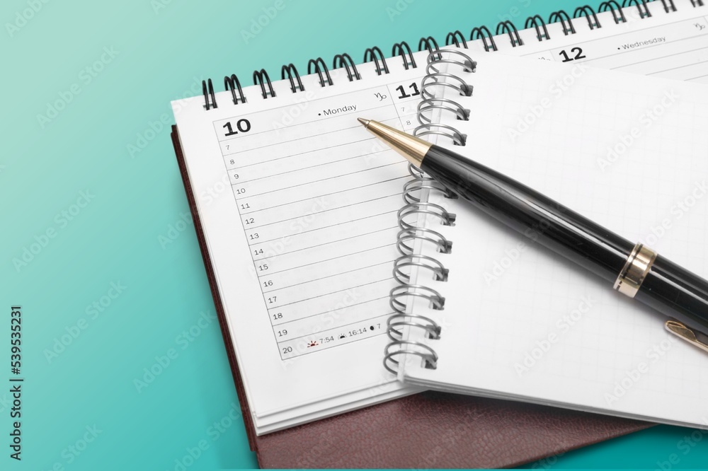 Classic white desktop calendar on desk Classic white desktop calendar on desk