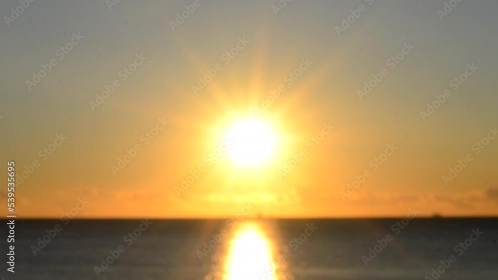 Blurred background. The sun shining in the sky during sunset dawn. Sunrise dawning sundown. Sunny path, sunny walkway on the surface of sea waves. Sunlight. Sea landscape. Natural blurry bokeh texture Blurred background. The sun shining in the sky during sunset dawn. Sunrise dawning sundown. Sunny path, sunny walkway on the surface of sea waves. Sunlight. Sea landscape. Natural blurry bokeh texture