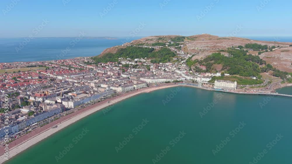 Llandudno, UK: Aerial view of city in Wales, seaside resort with North Shore Beach, blue waters of Atlantic Ocean in summer, sunny day, clear blue sky - landscape panorama of United Kingdom from above Llandudno, UK: Aerial view of city in Wales, seaside resort with North Shore Beach, blue waters of Atlantic Ocean in summer, sunny day, clear blue sky - landscape panorama of United Kingdom from above