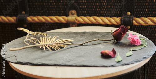Fototapeta Naklejka Na Ścianę i Meble -  dry rose placed on a stone plate