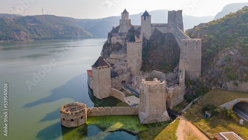 Aerial photography of Golubac medieval fortress located on the Danube river on Serbian bank. Photography was shot from a drone at higher altitude with camera tilted for a top view of the citadel.
