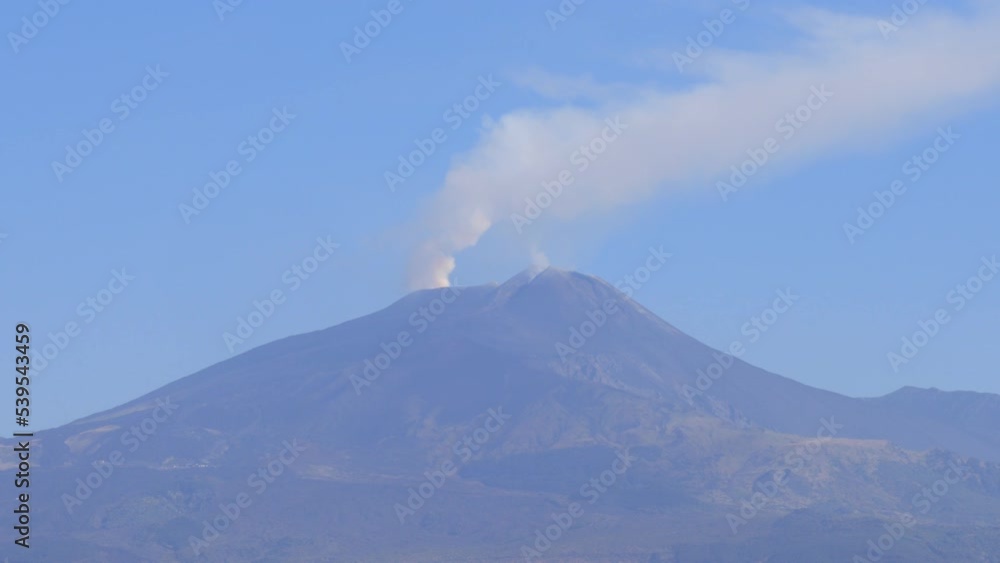 Etna volcano with smoke escaping from the craters of the volcano - view from Catania, Sicily (Italy) Etna volcano with smoke escaping from the craters of the volcano - view from Catania, Sicily (Italy)
