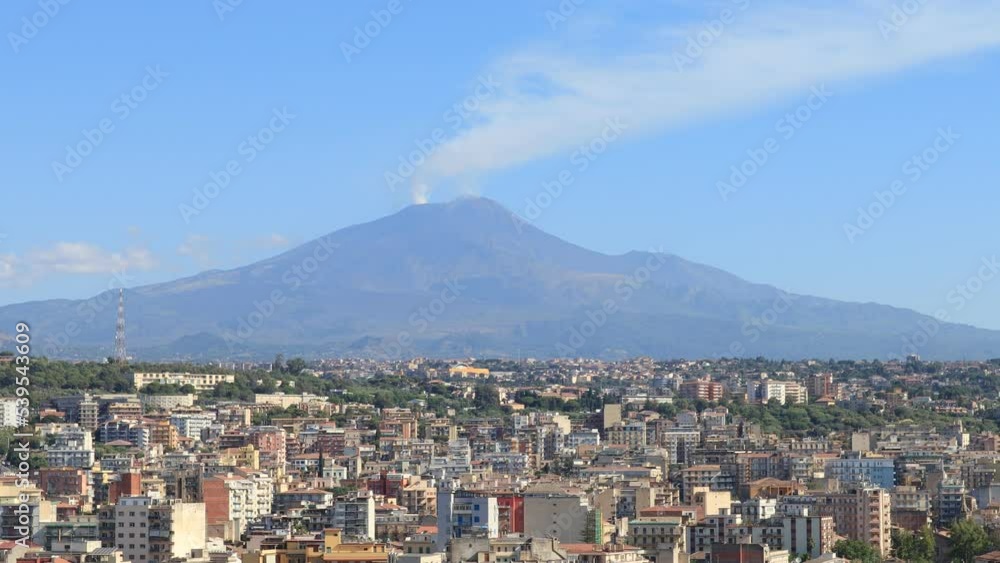 Etna volcano with smoke escaping from the craters of the volcano - view from Catania, Sicily (Italy) Etna volcano with smoke escaping from the craters of the volcano - view from Catania, Sicily (Italy)
