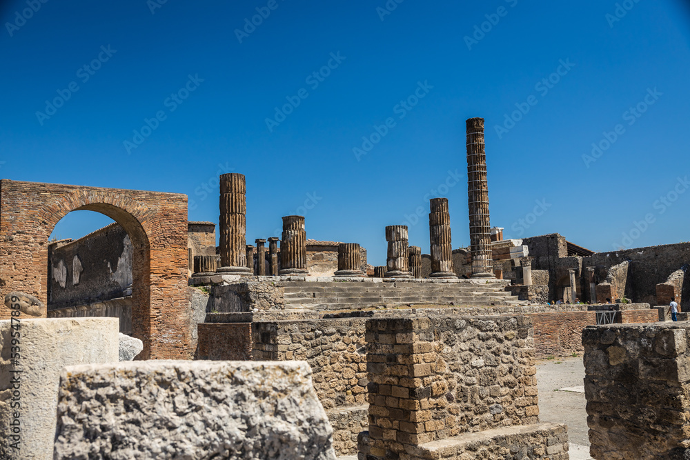The ruins of Pompeii with a clear blue sky in Italy.