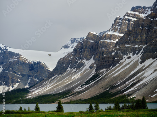 Steep slopes of the snow covered Canadian Rockies on the side of Bow Lake in BANFF NATIONAL PARK Canada photo