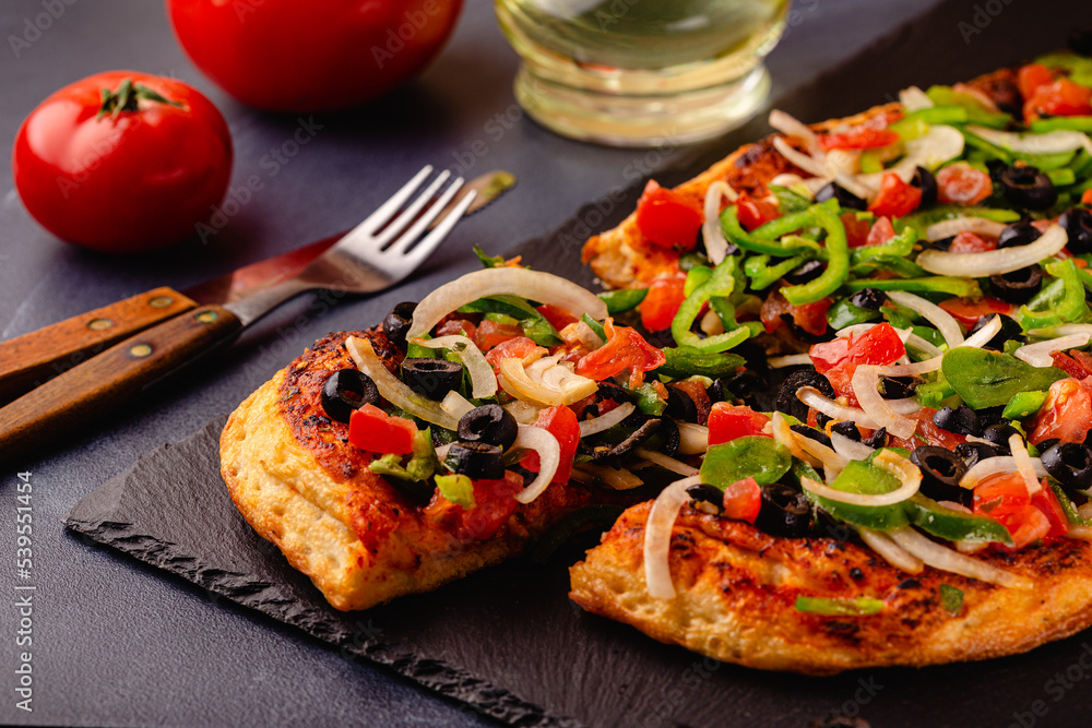 Homemade vegan pizza with tomatoes, peppers, olives, onions. Homemade vegan pizza with tomatoes, peppers, olives, onions.