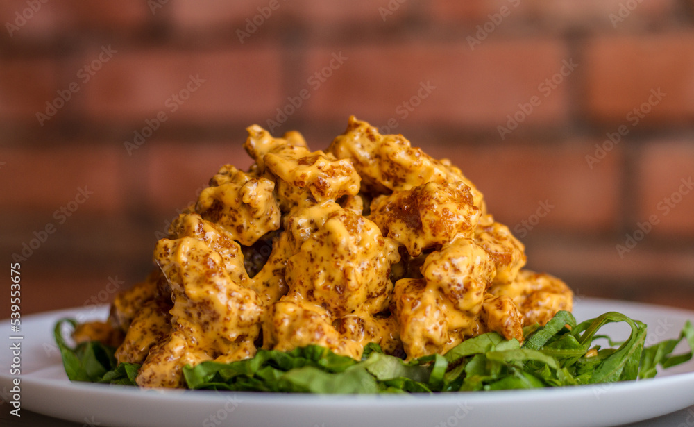 CHICKEN DYNAMITE served in a dish isolated on table side view CHICKEN DYNAMITE served in a dish isolated on table side view