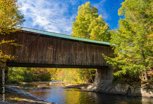 Side view of Montgomery covered bridge near Waterville in Vermont during the fall