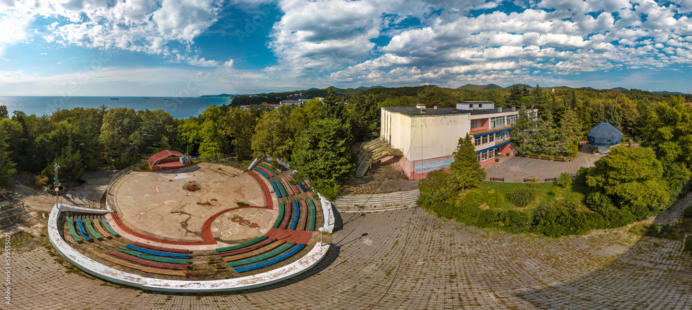 dance floor with a stage and benches for spectators in the old children's pioneer camp, built during the USSR, with the symbols of the 1980 Olympics - view from above