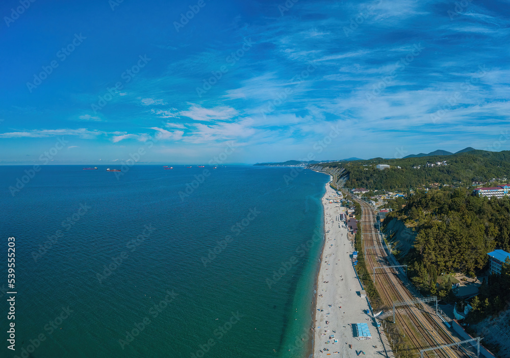 fantastic aerial view over the sea near the Black Sea beaches and wooded mountains near the city of Tupse (South of Russia) on a sunny summer day
