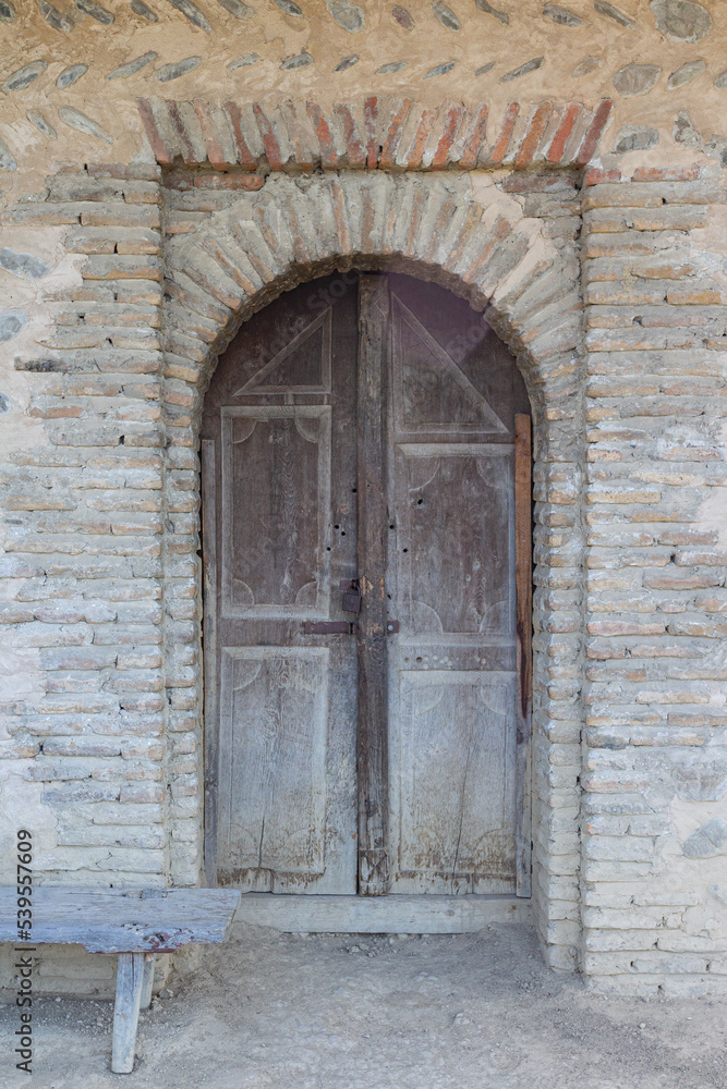 Ancient wooden door in a historic brick building in Tbilisi Open Air Museum of Ethnography. Georgia country