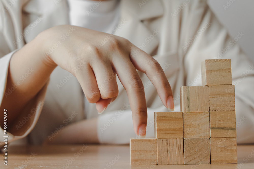 Hand walk on wood cube block stacking as step stair. business growth to success Hand walk on wood cube block stacking as step stair. business growth to success