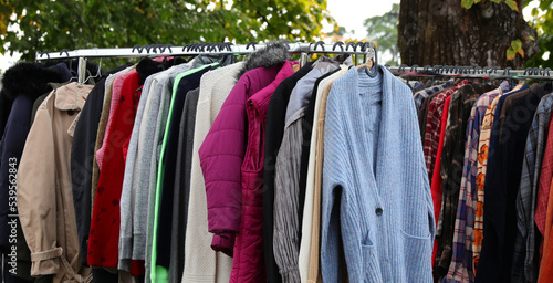 vintage used and new clothes for sale in the stall stand at the flea market