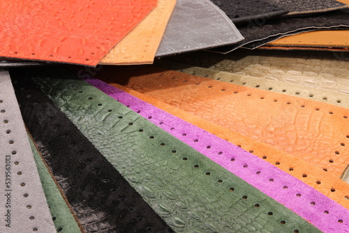 cut pieces of worked leather for the creation of fashion accessories photo