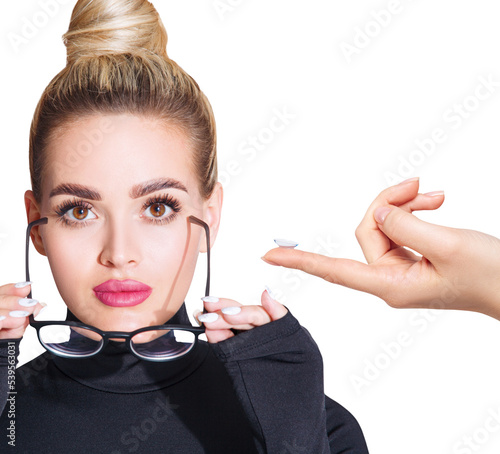 Принти на полотні Young woman in glasses decides to wear contact lenses.