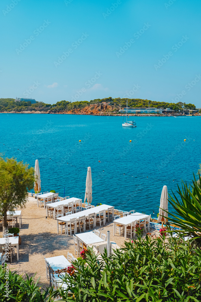 lonley tables at the Vouliagmeni bay, Greece