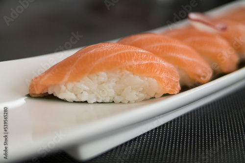 White plate with salmon and rice sushi