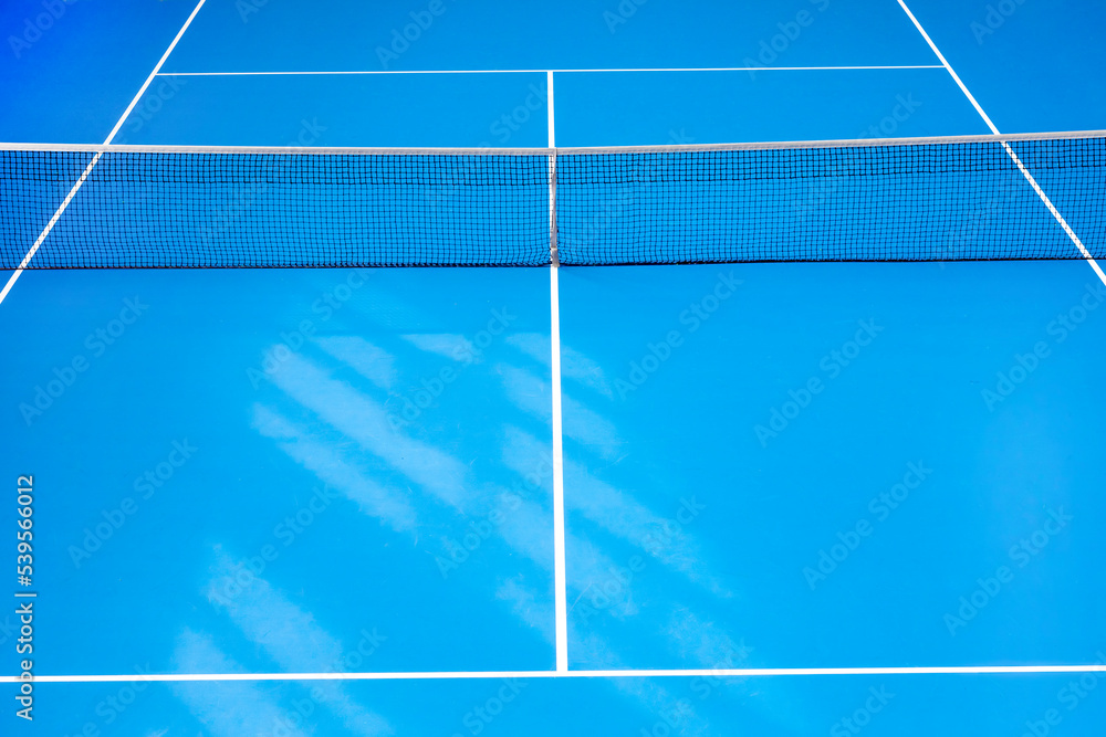 Blue paddle tennis and hard court with shadows. Tennis compettion concept. Horizontal sport theme poster, greeting cards, headers, website and app. Blue paddle tennis and hard court with shadows. Tennis compettion concept. Horizontal sport theme poster, greeting cards, headers, website and app.