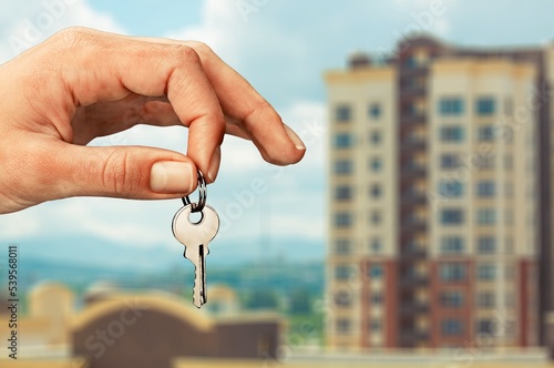 Real estate concept, hand hold a key from house