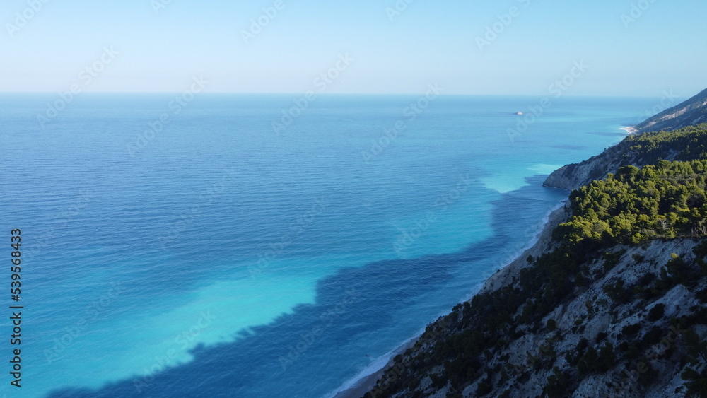 The beautiful turquoise blue color of the Ionian Sea that surrounds the Greek island of Lefkada and Potro Katsiki beach The beautiful turquoise blue color of the Ionian Sea that surrounds the Greek island of Lefkada and Potro Katsiki beach