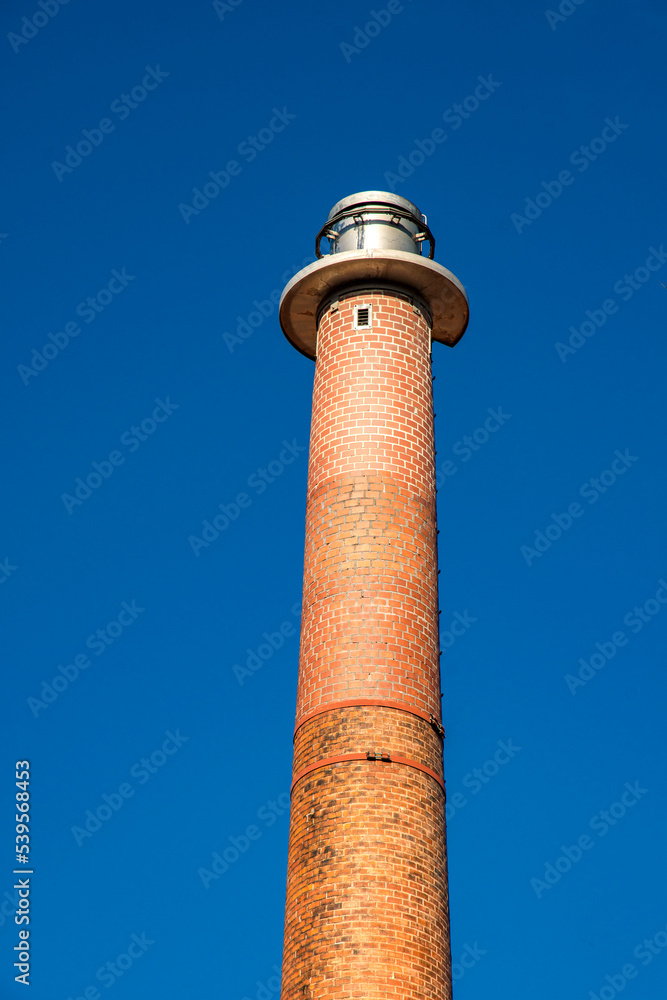 Industrial fireplace made of bricks in front of a blue sky