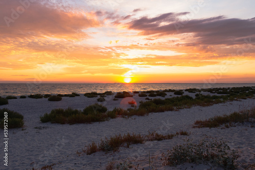 Amazing Black sea sunset  Nature landscape background. Drama sky  sun and clouds. Golden hour at the ocean romantic evening. Tropical island summer paradise. Wild tourism in camp.