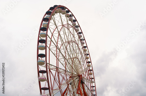 Attraction ferris wheel on the background of a stormy sky.