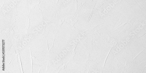 Texture background of white concrete wall. Empty light cement wall. Light white panoramic background with space for text. Clean stucco rough wall. One color monochrome structure.