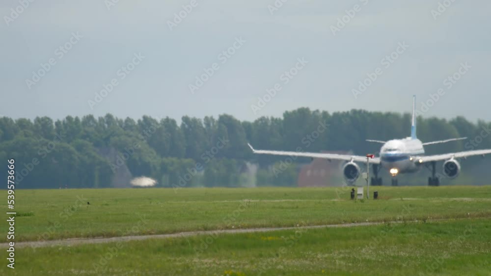 Unrecognizable airliner accelerating to take off. Airplane on the airfield on a summer day. Haze on the runway Unrecognizable airliner accelerating to take off. Airplane on the airfield on a summer day. Haze on the runway