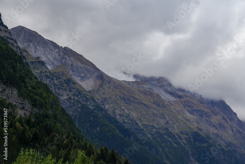 magnificent view of Pyrenees mountains with rock outcrops and forest covered slopes