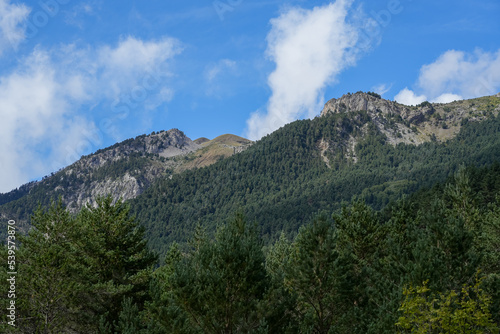 magnificent view of Pyrenees mountains with rock outcrops and forest covered slopes