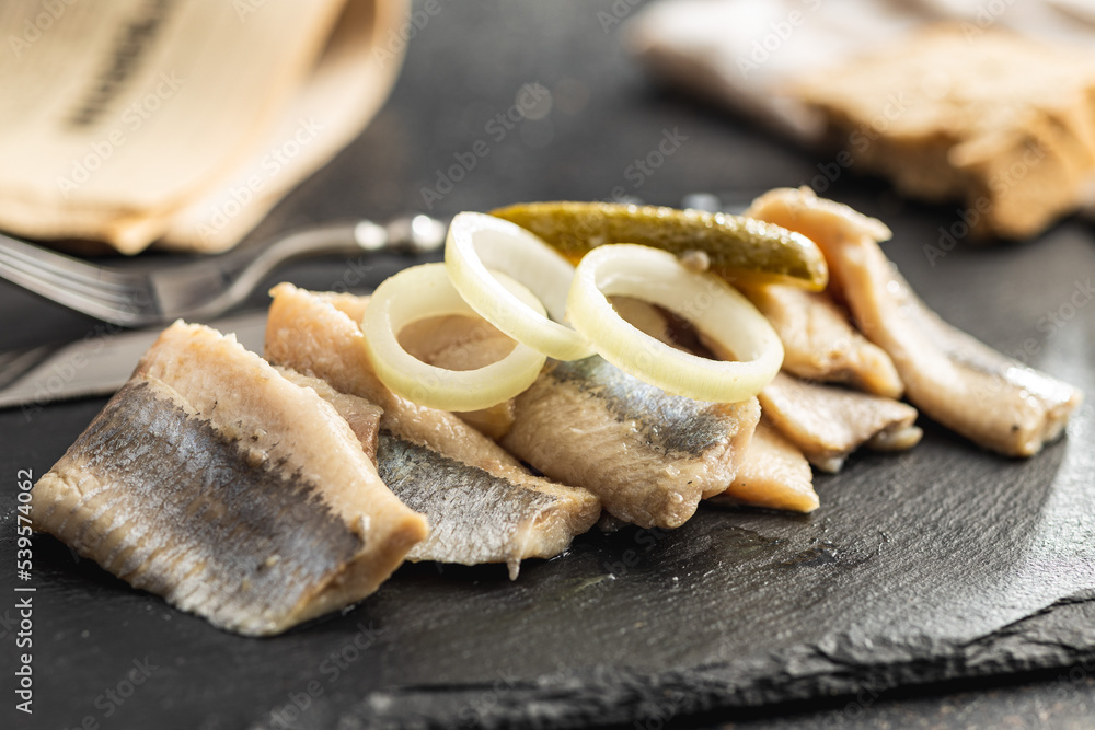 Marinated herring fish on kitchen table. Marinated herring fish on kitchen table.