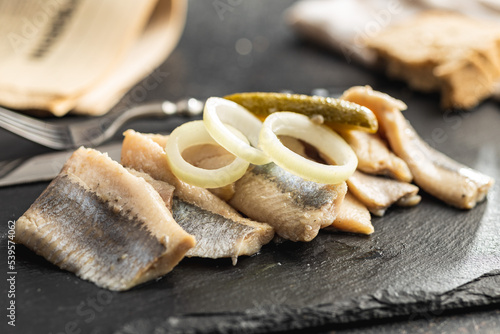 Marinated herring fish on kitchen table.
