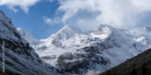 magnificent view of a long glacial valley through snow and cloud topped Spanish Pyrenees mountains © Martin