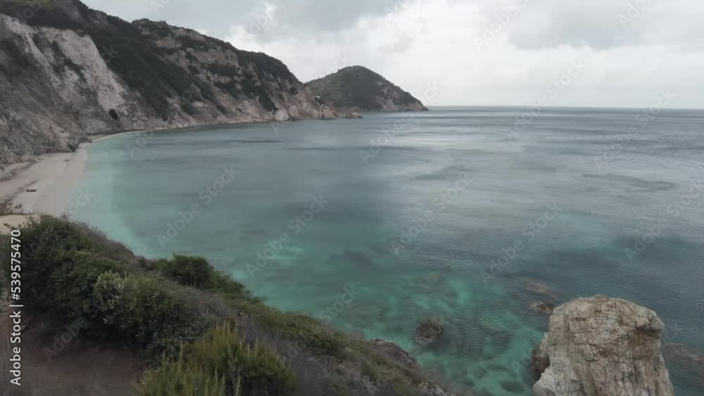 Cliff panorama in cloudy sea day. Mediterranean landscape from cliff and clear sea water.