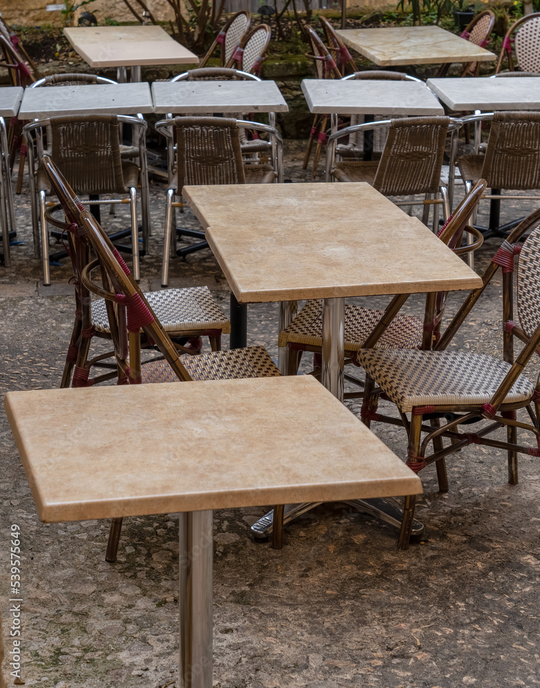 tables and chairs in a cobbled street for drinking and dining outside