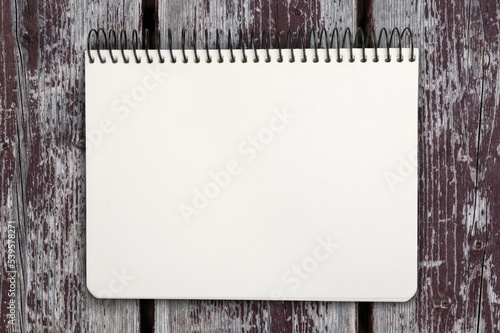 Fotografia Quote concept with a white notebook page placed on a wooden background