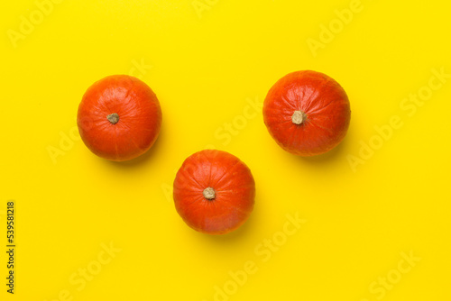 Pumpkins on color background  top view