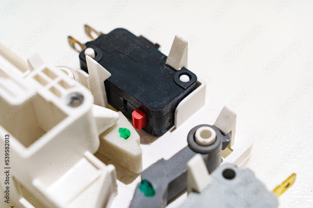 end microswitches on a white background. Microwave oven parts. end microswitches on a white background. Microwave oven parts.