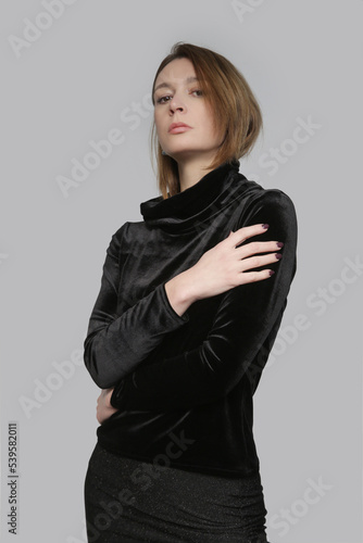 Serie of studio photos of female model wearing plush black turtleneck, elegant yet cozy and warm clothng. photo