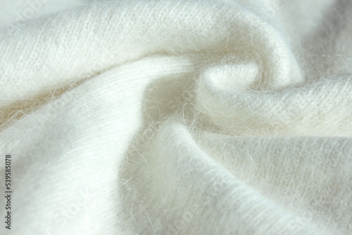 Background fabric texture of Angora. Background texture of white pattern knitted fabric made of cotton or wool or angora close up. photo