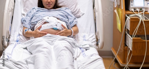 A pregnant woman being monitored before labor. Contractions and cardiogram in the hospital. photo