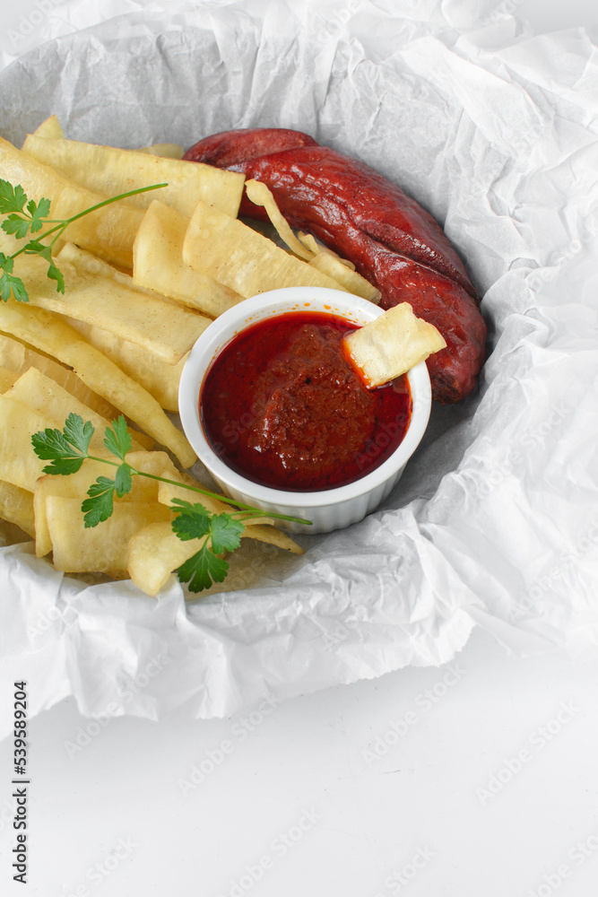 slices of fried yam, sausage and sauce, slices fried yam and stew on ...