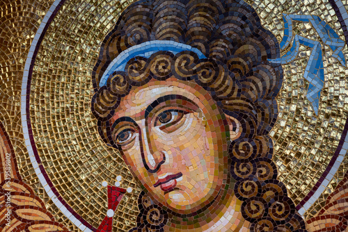 Detail of byzantine or orthodox mosaic icon depicting the head of an Angel. photo