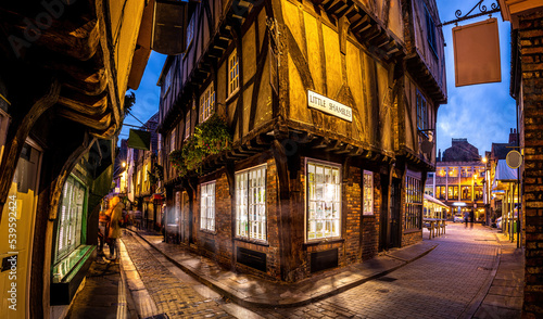 A Chirstmas night view of Shambles, a historic street in York featuring preserved medieval timber-framed buildings with jettied floors photo